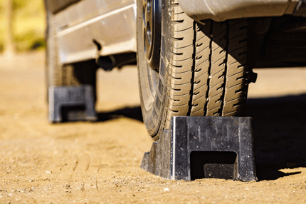 Stops under motorhome wheels on a dirt road