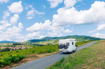 A motor home driving along a french countryside road